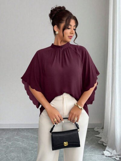 Blouse ample à encolure ronde, manches froncées et ourlet ondulé